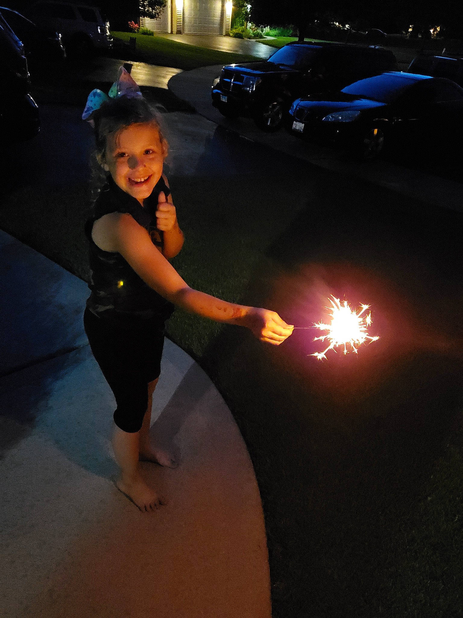Kathleen is registered to the contest to win money with this photo: fun, joy, light, midnight, night, person, sparkler, vacation