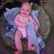 Archer joined the competition — help win amazing prizes! baby, infant, smiling, diaper, blanket, bed, carpet, indoor, child, happy, person, cute, soft, plush, playful, comfort, cozy, patterned, toddler, relaxed