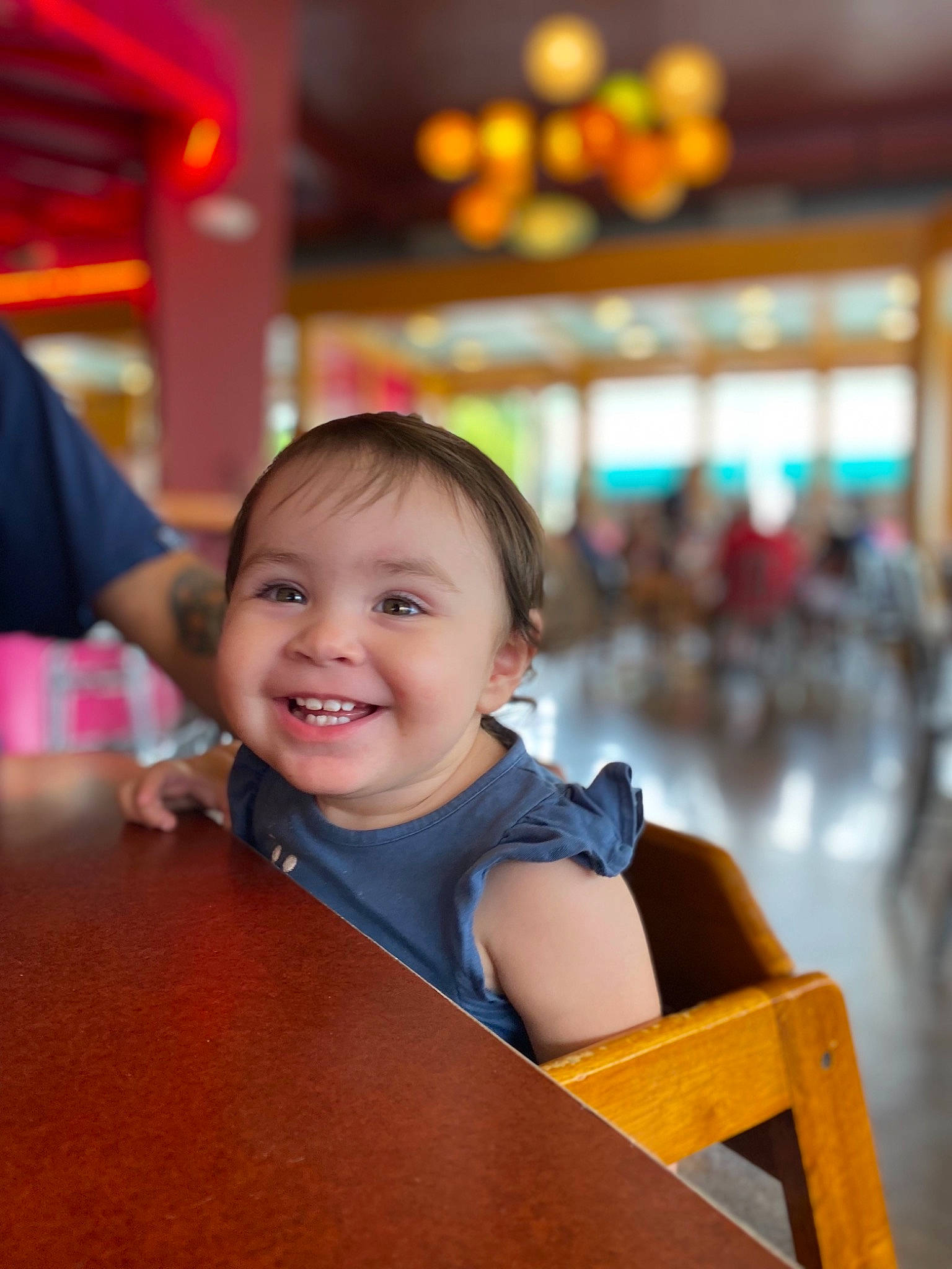 Lily is registered to the contest to win money with this photo: amusement_ride, beauty, child, chin, city, event, fun, happy, human_settlement, joy, leisure, orange, person, recreation, sitting, skin, smile, t_shirt, toddler, travel