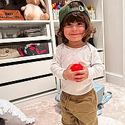 Ayan is registered to the contest to win money with this photo: ball, baseballcap, cap, child, clothing, cricket, cricketball, face, female, furniture, girl, hat, head, indoors, pants, person, photography, portrait, shelf, sport