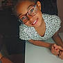 Jalina participe au concours pour gagner de l'argent avec cette photo : child, glasses, smile, table, hand, indoor, person, leisure, portrait, young, casual, clothing, face, happy, human, furniture, skin, arm, eyewear, friendly