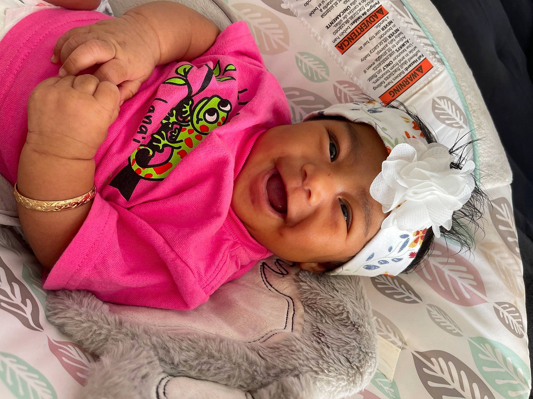 Kuuipomakamaeonalani is registered to the contest to win money with this photo: arm, baby, cheek, child, eyebrow, eyelash, finger, hand, happy, headwear, lip, magenta, mouth, nose, pattern, person, pink, skin, sleeve, smile