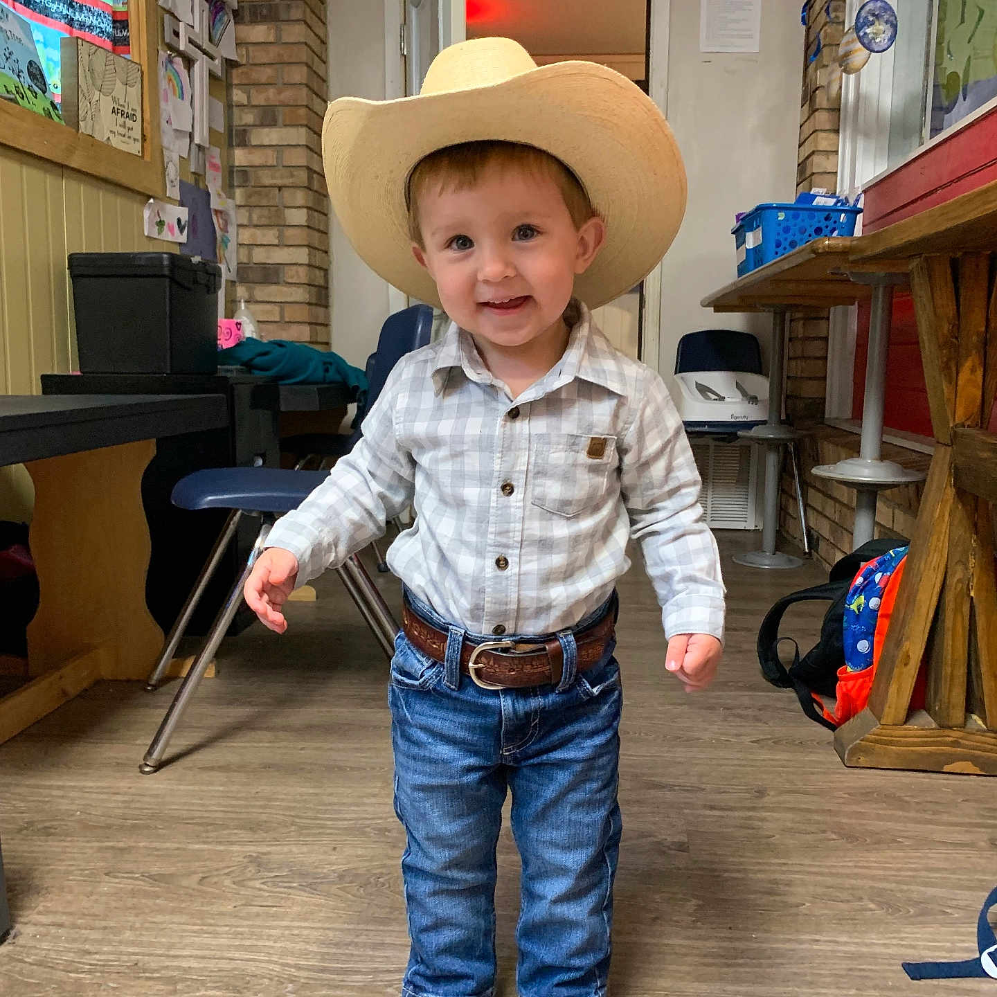 Jude is registered to the contest to win money with this photo: accessories, belt, box, boy, child, clothing, cowboyhat, face, footwear, hat, head, jeans, male, pants, person, photography, portrait, shoe, sunhat, wood