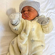 Ian is registered to the contest to win money with this photo: baby, newborn, infant, sleeping, mittens, hat, onesie, cozy, bed, blanket, cute, soft, child, person, indoor, resting, pajamas, white, fabric, sleep
