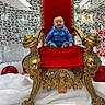 baby, child, throne, red_velvet, golden_chair, smiling, blue_outfit, indoor, decorations, holiday, festive, ornate, luxury, seat, happy, portrait, winter, lattice_background, crown, royalty