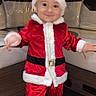 Alone a rejoint le concours — aidez-le/la à gagner de superbes lots ! child, baby, santa_claus_costume, red_clothing, holiday, smile, barefoot, indoor, flooring, wood_floor, seating, cushion, furniture, festive, hat, person, cute, portrait, christmas, young_child