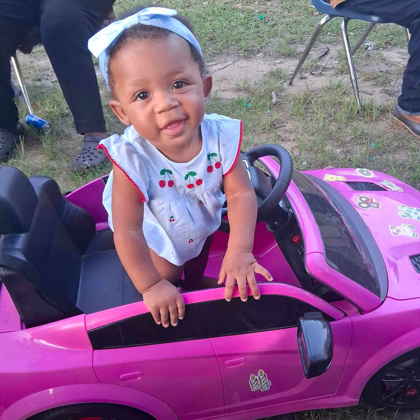 Paislee joined the competition — help win amazing prizes! baby, child, toddler, smiling, portrait, toy_car, pink_car, outdoor, garden, grass, bow, dress, cherries, steering_wheel, playtime, vehicle, sitting, standing, adults, happy