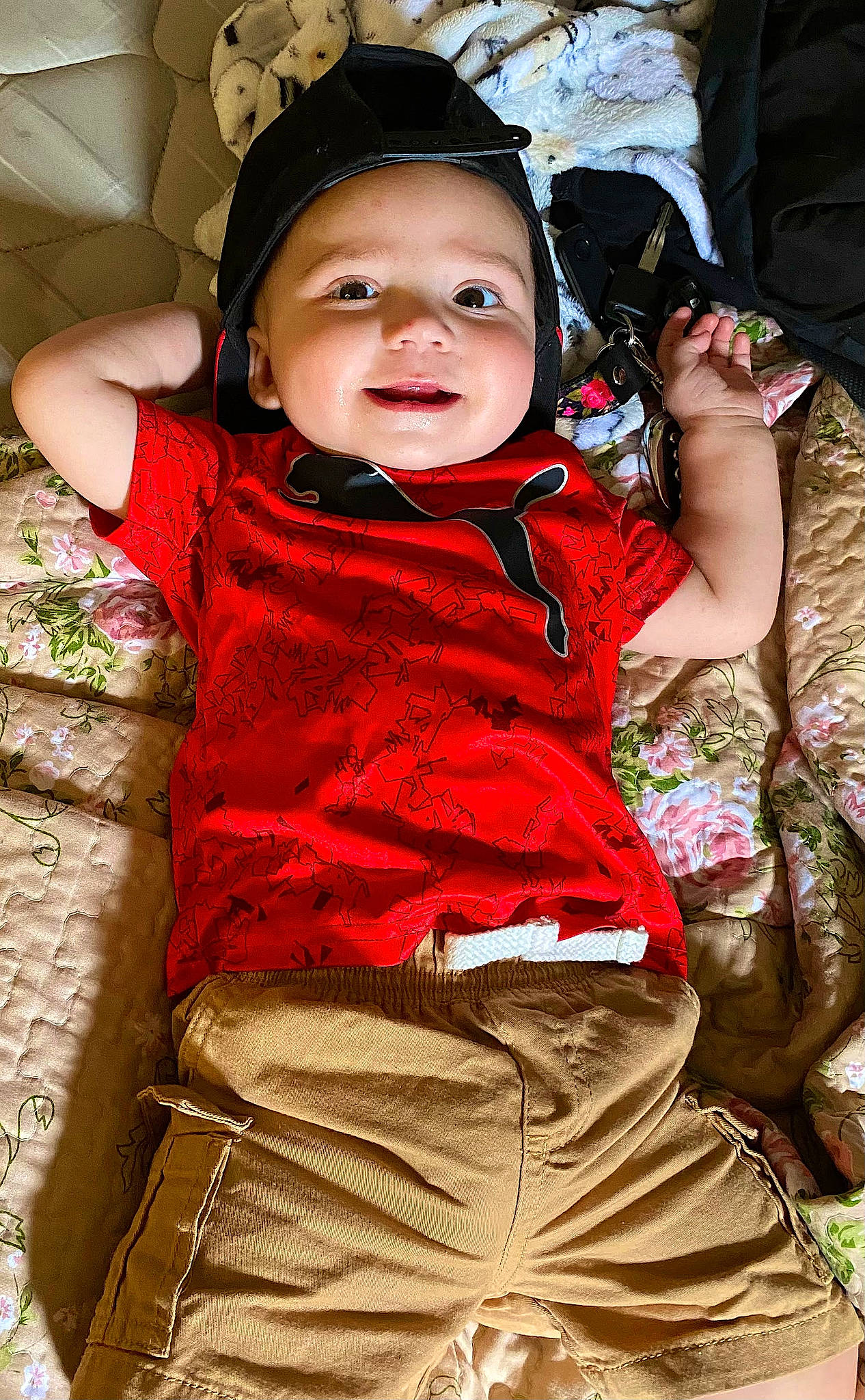 Zion is registered to the contest to win money with this photo: baby, baby_products, baby_toddler_clothing, child, cool, fashion_accessory, flash_photography, fun, grass, hand, happy, headwear, leisure, magenta, people_in_nature, person, pink, sitting, skin, sleeve