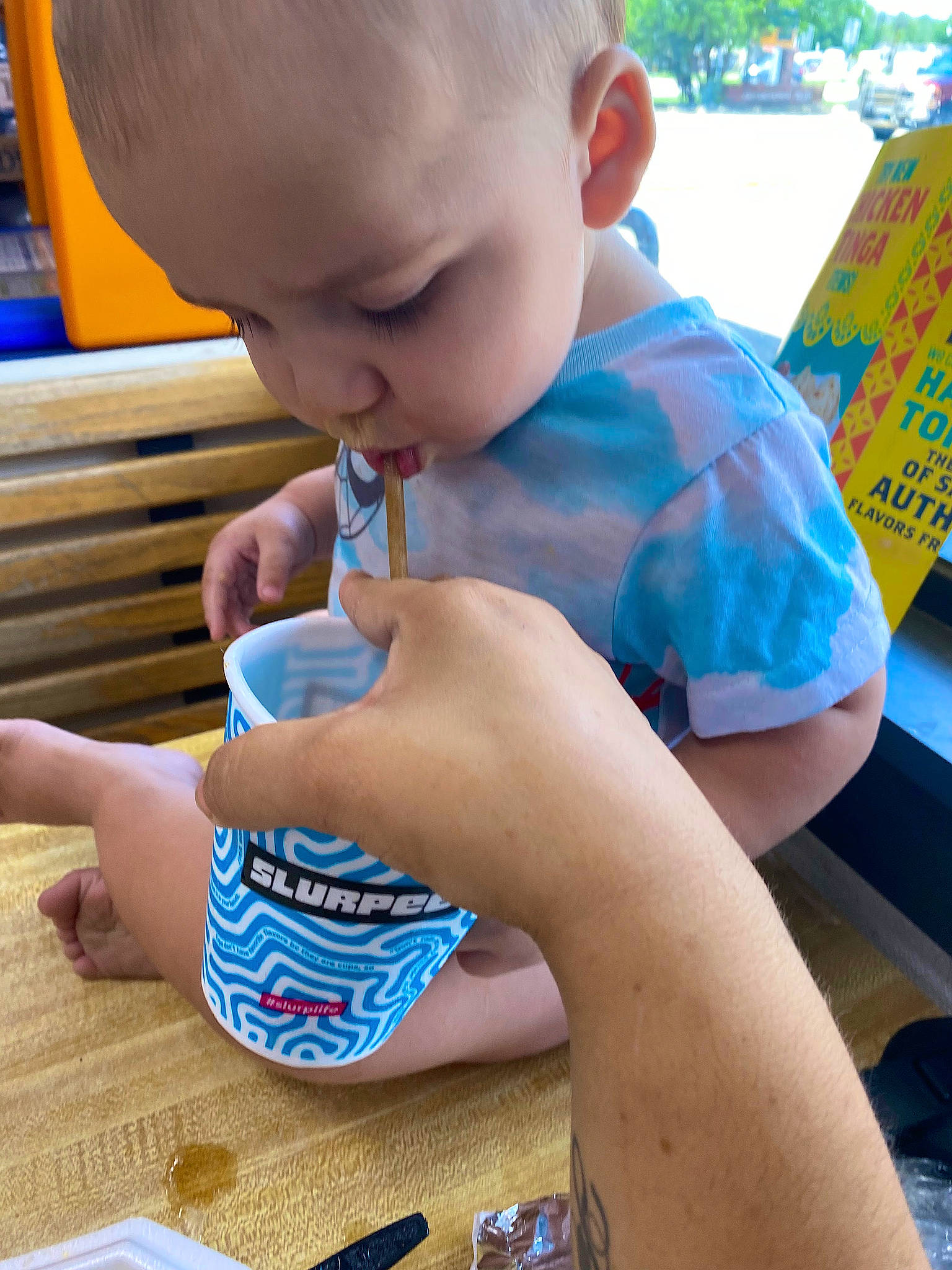 Zion is registered to the contest to win money with this photo: baby, baby_toddler_clothing, child, electric_blue, finger, fun, hand, leisure, nail, person, play, recreation, sharing, sitting, t_shirt, table, tableware, thumb, toddler, wood