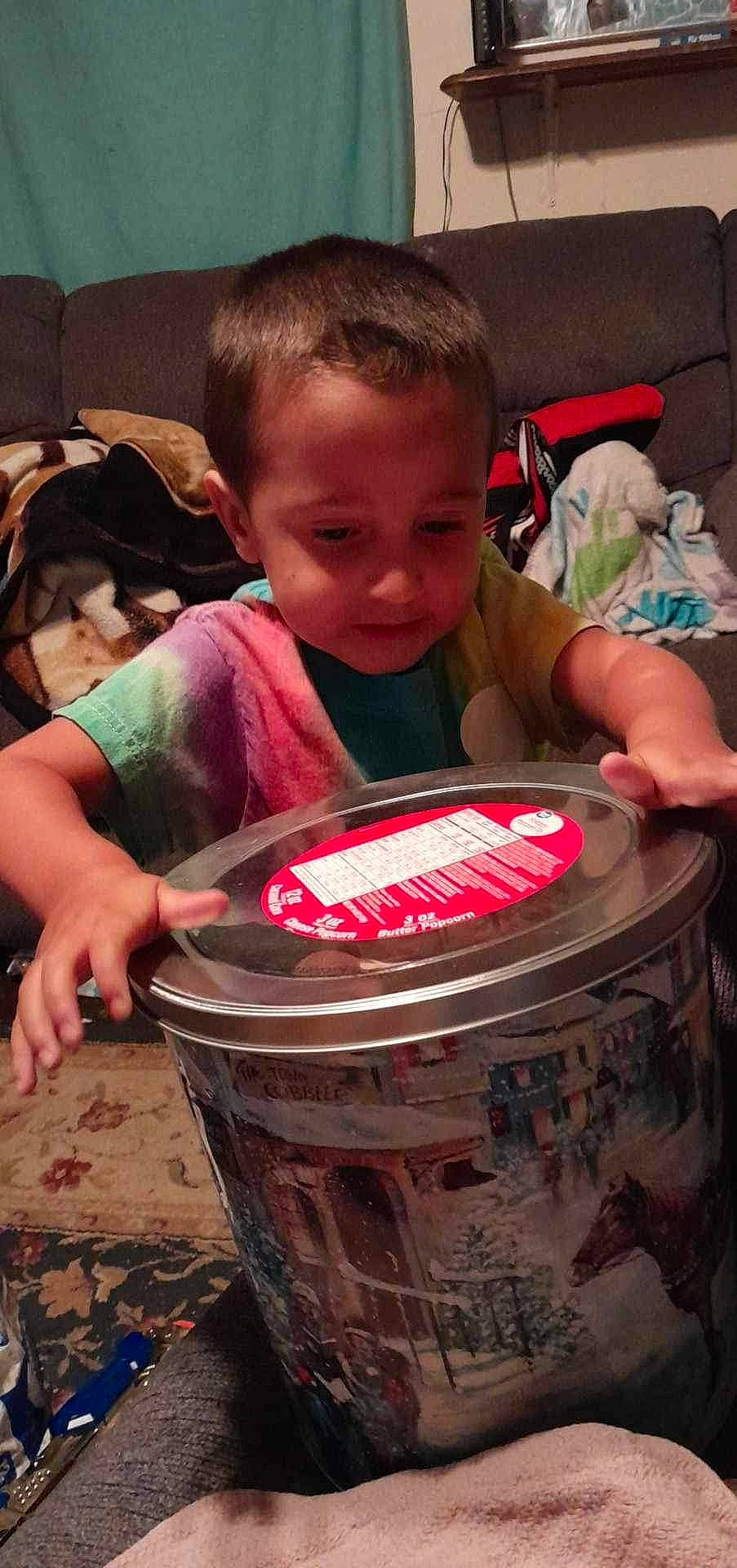Elijah is registered to the contest to win money with this photo: automotive_tire, automotive_wheel_system, baby, birthday, bucket, child, drink, drum, drumhead, drums, event, fun, hand_drum, membranophone, person, sharing, sitting, t_shirt, toddler, tom_tom_drum