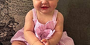 Marnie joined the competition — help win amazing prizes! baby, baby_girl, child, closeup, couch, cute, furniture, happy, headband, indoor, infant, person, pink_bow, pink_dress, portrait, sitting, smiling, sock, white_socks, young_child