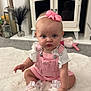 Marnie joined the competition — help win amazing prizes! baby, child, pink_overalls, headband, bow, white_rug, carpet, white_shoes, ribbons, blue_eyes, indoor, home, decor, cabinet, carpeted_floor, cute, sitting, infant, person, portrait