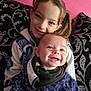 Teddy is registered to the contest to win money with this photo: baby, blanket, child, clothing, couch, cute, fabric, face, hair, happy, head, hug, indoors, pillow, pink_wall, portrait, seated, sibling, smile, warm