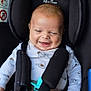 baby, car_seat, child, infant, smiling, happy, pacifier, safety_harness, onesie, cute, seatbelt, black, white_clothing, indoor, closeup, small_child, infant_face, baby_clothes, hands, head