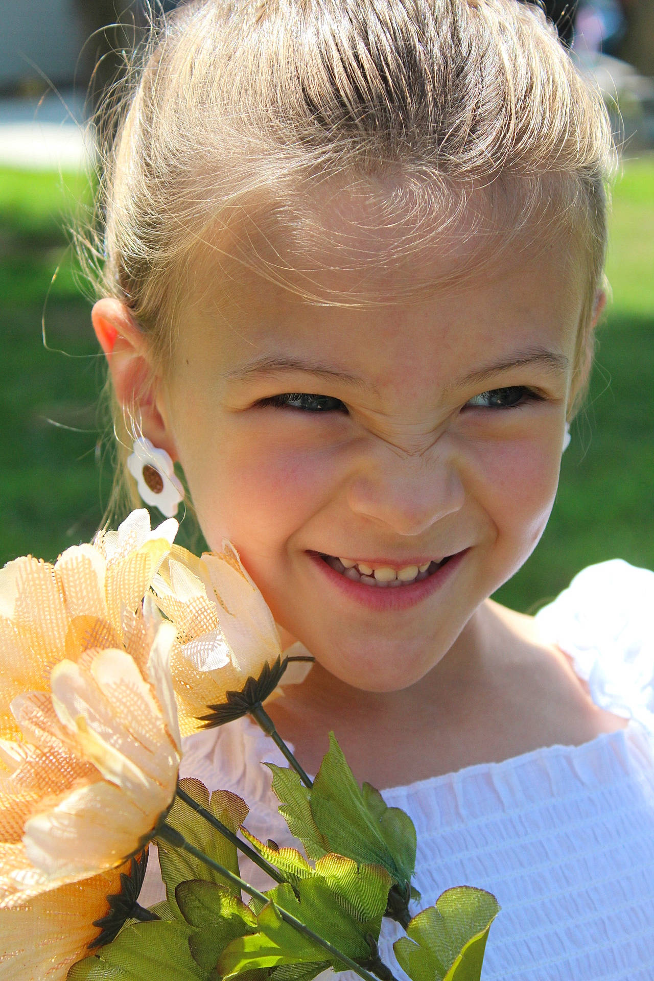 Gracelyn joined the competition — help win amazing prizes! beauty, blond, child, close_up, eye, facial_expression, flower, flower_arranging, fun, grass, hair, happy, head, iris, joy, people_in_nature, person, petal, plant, skin