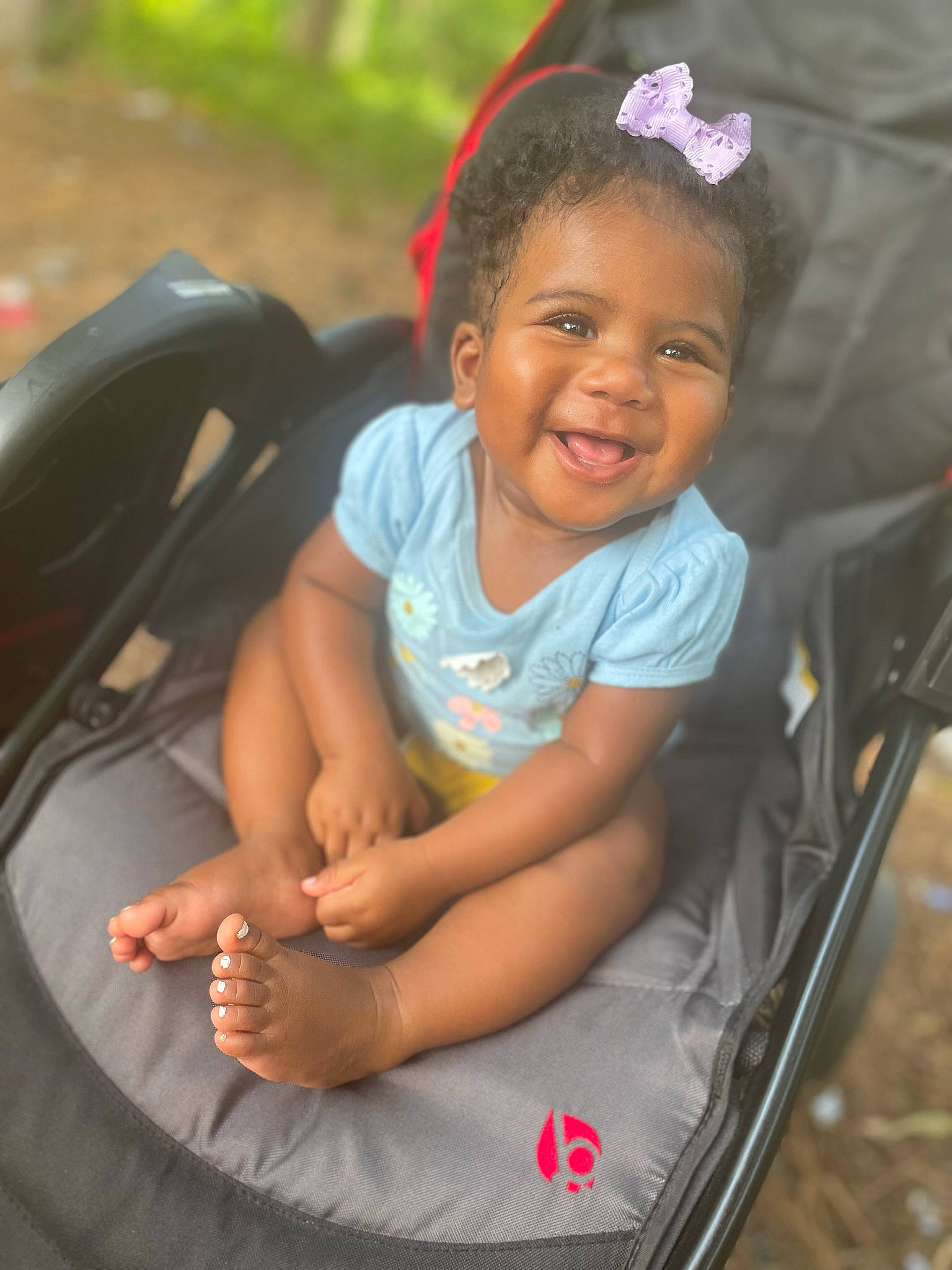 Kelsie is registered to the contest to win money with this photo: auto_part, automotive_exterior, automotive_tire, bumper, face, fun, grass, happy, leisure, mode_of_transport, motor_vehicle, mouth, person, plant, product, skin, smile, tire, toddler, vehicle_door