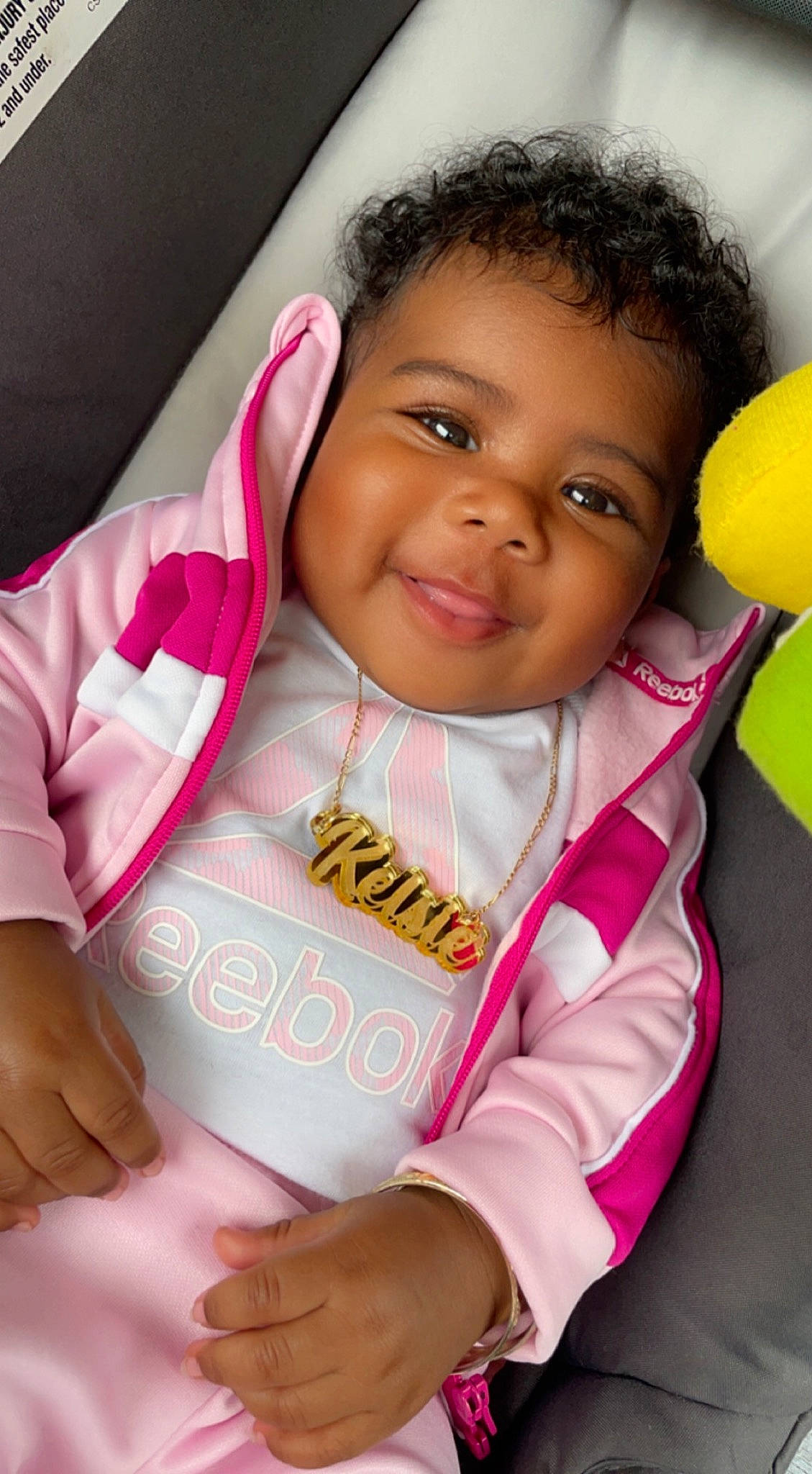 Kelsie is registered to the contest to win money with this photo: baby_toddler_clothing, balloon, cheek, eye, eyebrow, facial_expression, finger, gesture, hair, hand, happy, head, joy, lip, neck, nose, person, pink, skin, sleeve