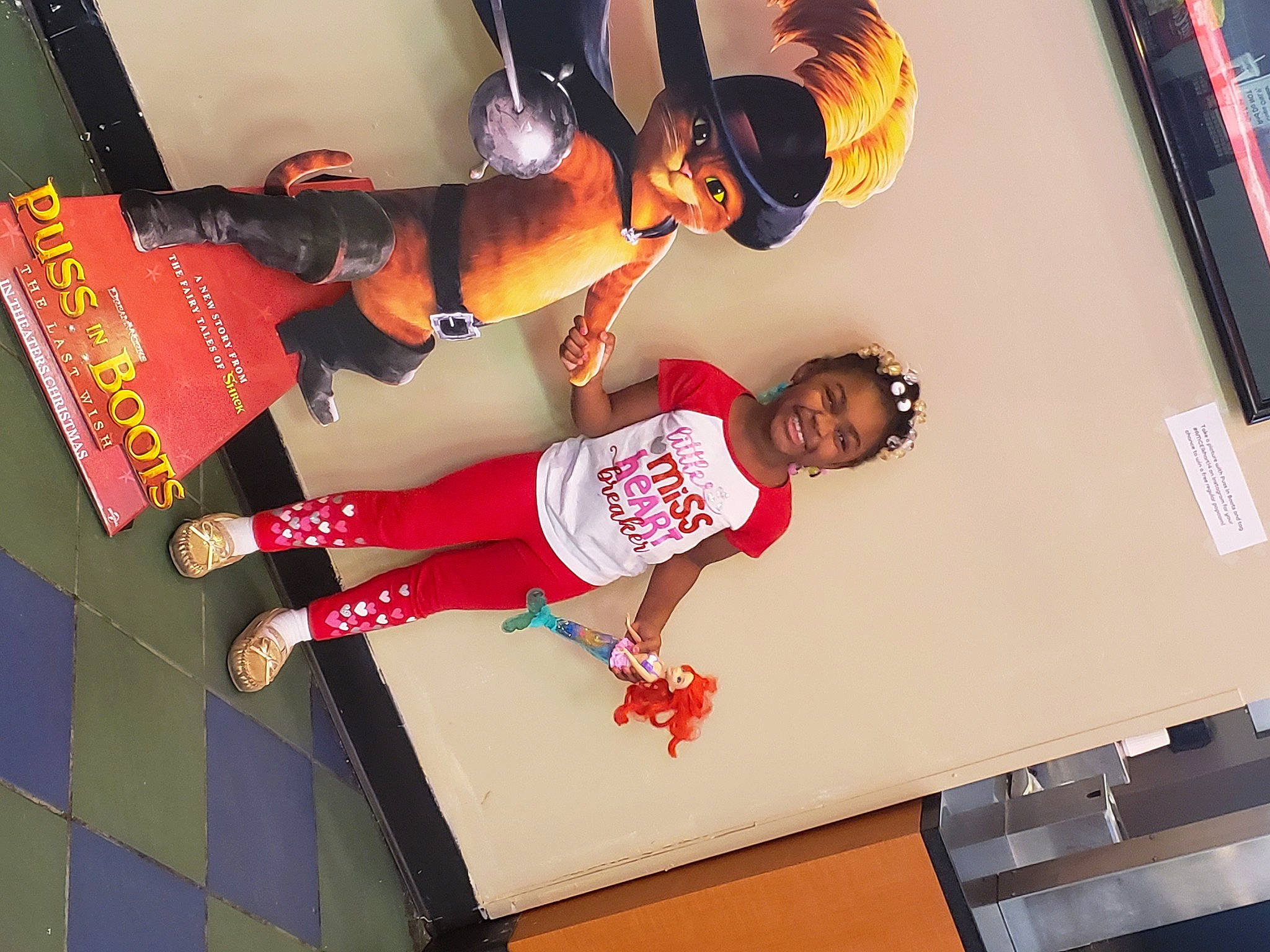 Myanna is registered to the contest to win money with this photo: advertising, carmine, elbow, event, fashion_design, font, fun, happy, human_leg, joy, knee, leg, leisure, person, room, sandal, shorts, smile, sportswear, t_shirt