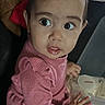 Yvette is registered to the contest to win money with this photo: child, toddler, pink_sweater, indoor, curious, face, hands, container, plastic, table, clothing, person, young_child, portrait, cute, baby, long_sleeve, sitting, head, expression
