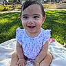 Yvette is registered to the contest to win money with this photo: baby, child, smiling, outdoor, grass, blanket, flower_pattern, dress, cute, happy, sitting, sunlight, park, nature, person, infant, young_child, portrait, daylight, skin