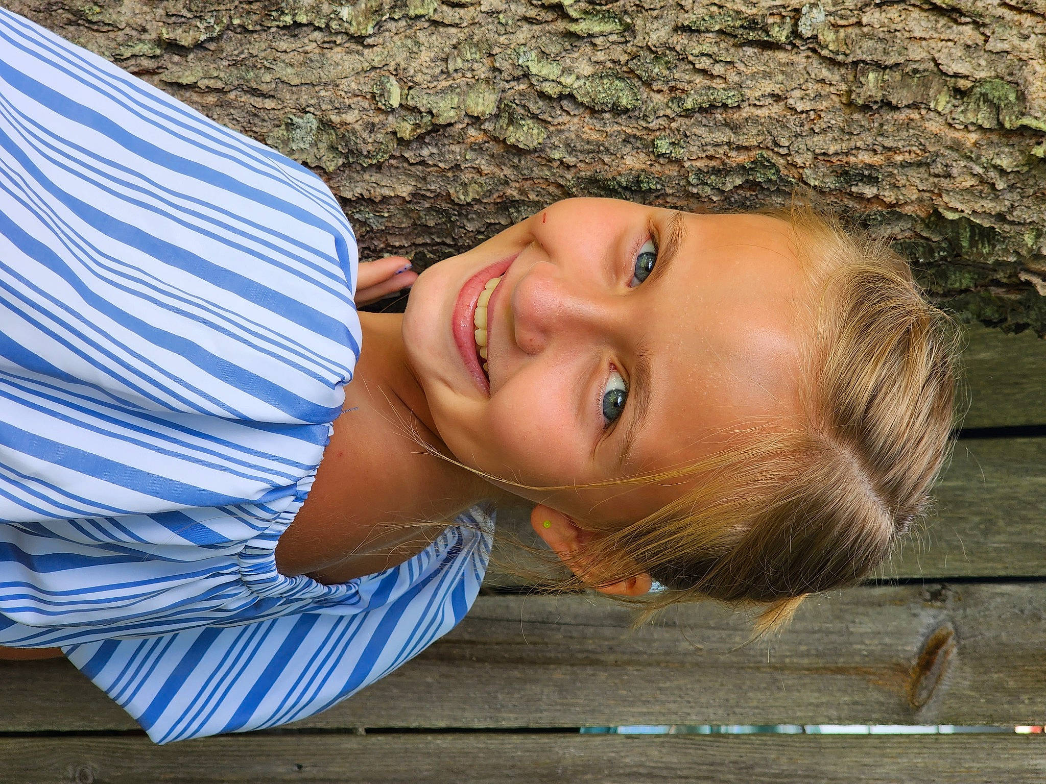 Kaylen is registered to the contest to win money with this photo: child, electric_blue, flash_photography, fun, grass, happy, joy, leisure, lip, nose, people_in_nature, person, photo_shoot, plant, portrait, portrait_photography, sitting, smile, tree, trunk