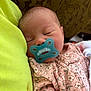 baby, newborn, pacifier, sleeping, infant, pink_clothing, floral_pattern, face, head, closed_eyes, soft_skin, cuddle, blanket, comfort, peaceful, child, portrait, indoors, human, resting