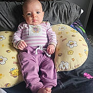 Karina joined the competition — help win amazing prizes! baby, infant, child, pillow, boppy_pillow, onesie, striped_clothing, purple_pants, tiny_toes, hands, face, eyes, bed, blanket, cute, indoor, portrait, furniture, nursery, relaxed