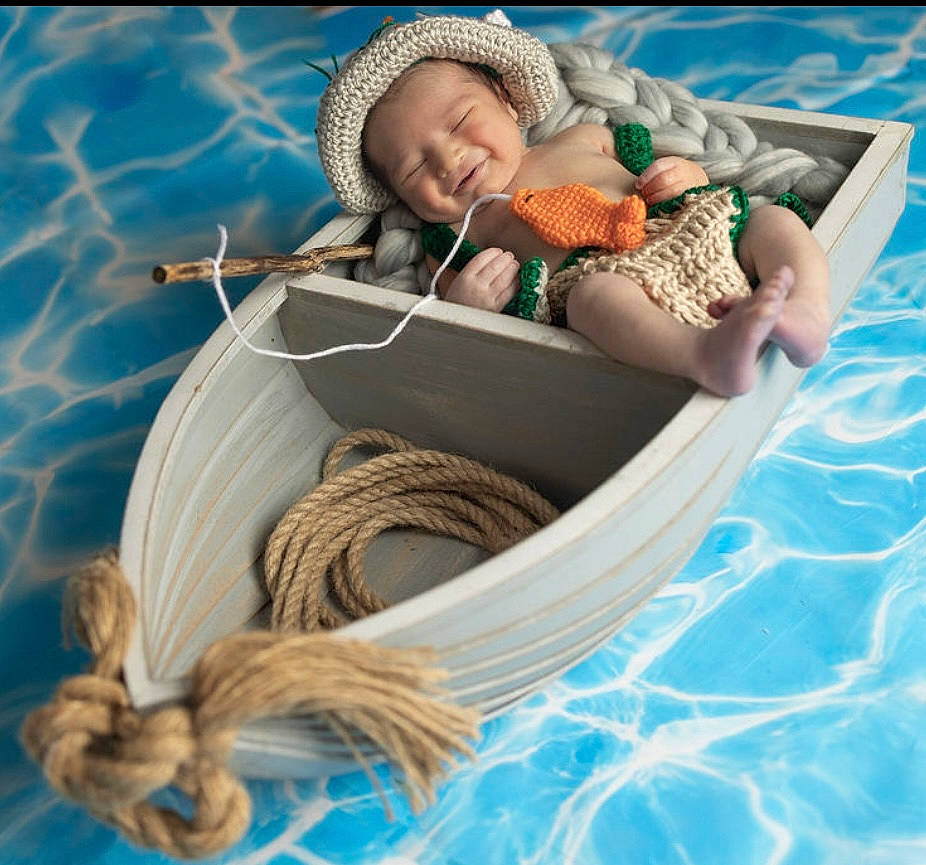 Fisher is registered to the contest to win money with this photo: baby, baby_products, baby_sleeping, basket, boats_and_boating_equipment_and_supplies, child, comfort, fun, grass, happy, hat, leisure, linens, person, recreation, rope, toddler, vacation, water, wicker