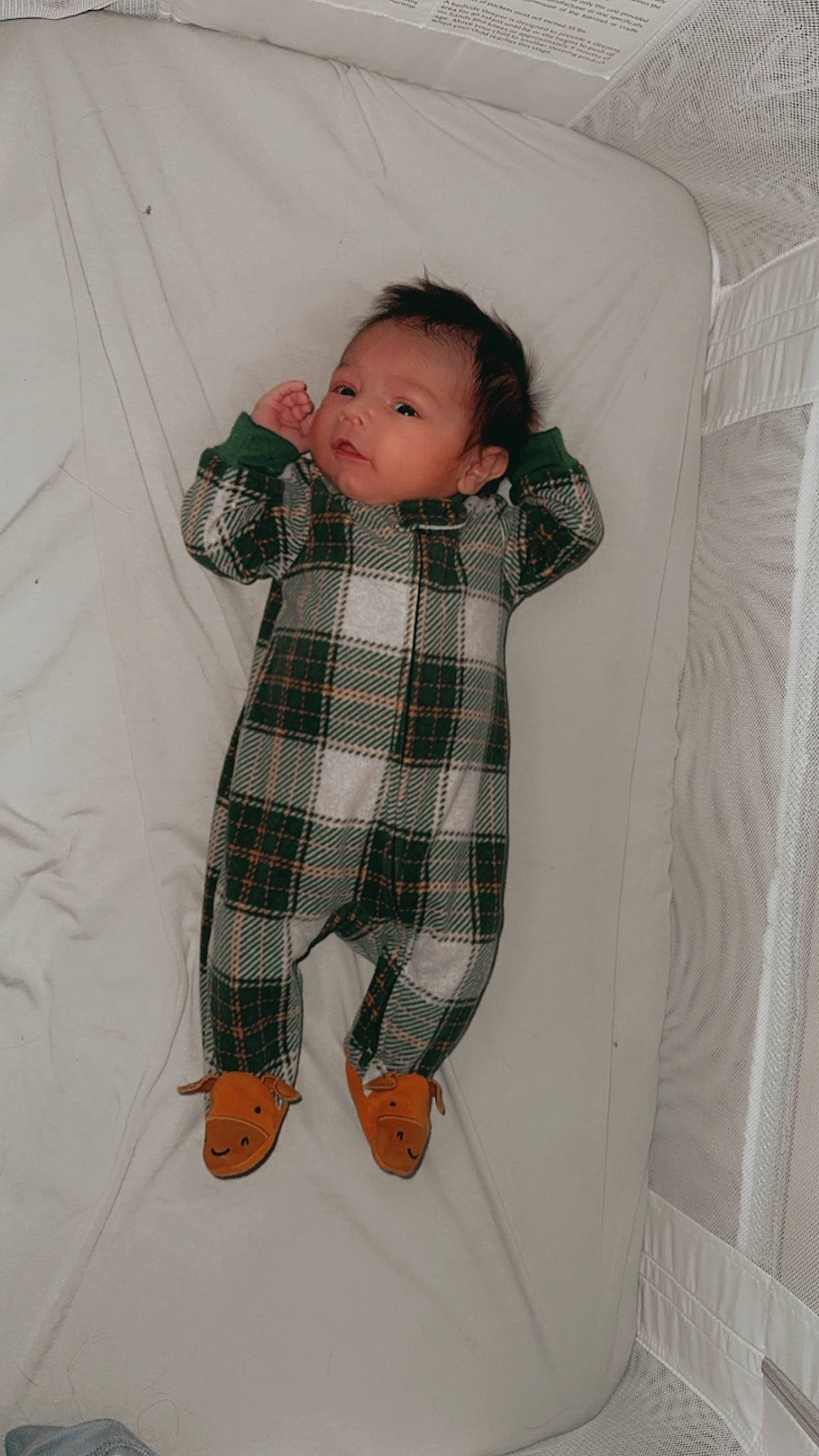 Fisher is registered to the contest to win money with this photo: baby, baby_products, baby_toddler_clothing, child, comfort, face, flooring, head, knee, linens, pattern, person, plaid, room, sitting, sleeve, sock, tartan, textile, toddler