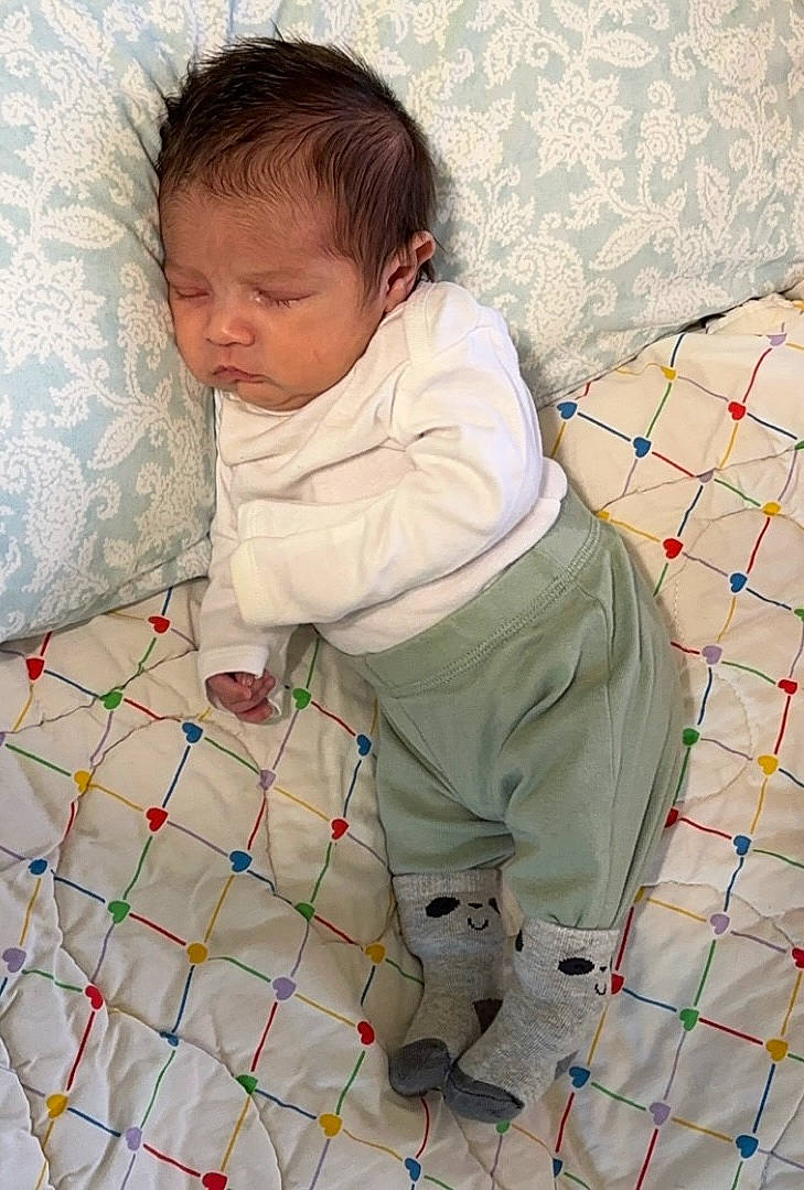 Fisher is registered to the contest to win money with this photo: baby, baby_products, baby_safety, baby_toddler_clothing, bedding, child, comfort, floor, flooring, fun, infant_bed, linens, net, pattern, person, play, room, sitting, sleeve, textile