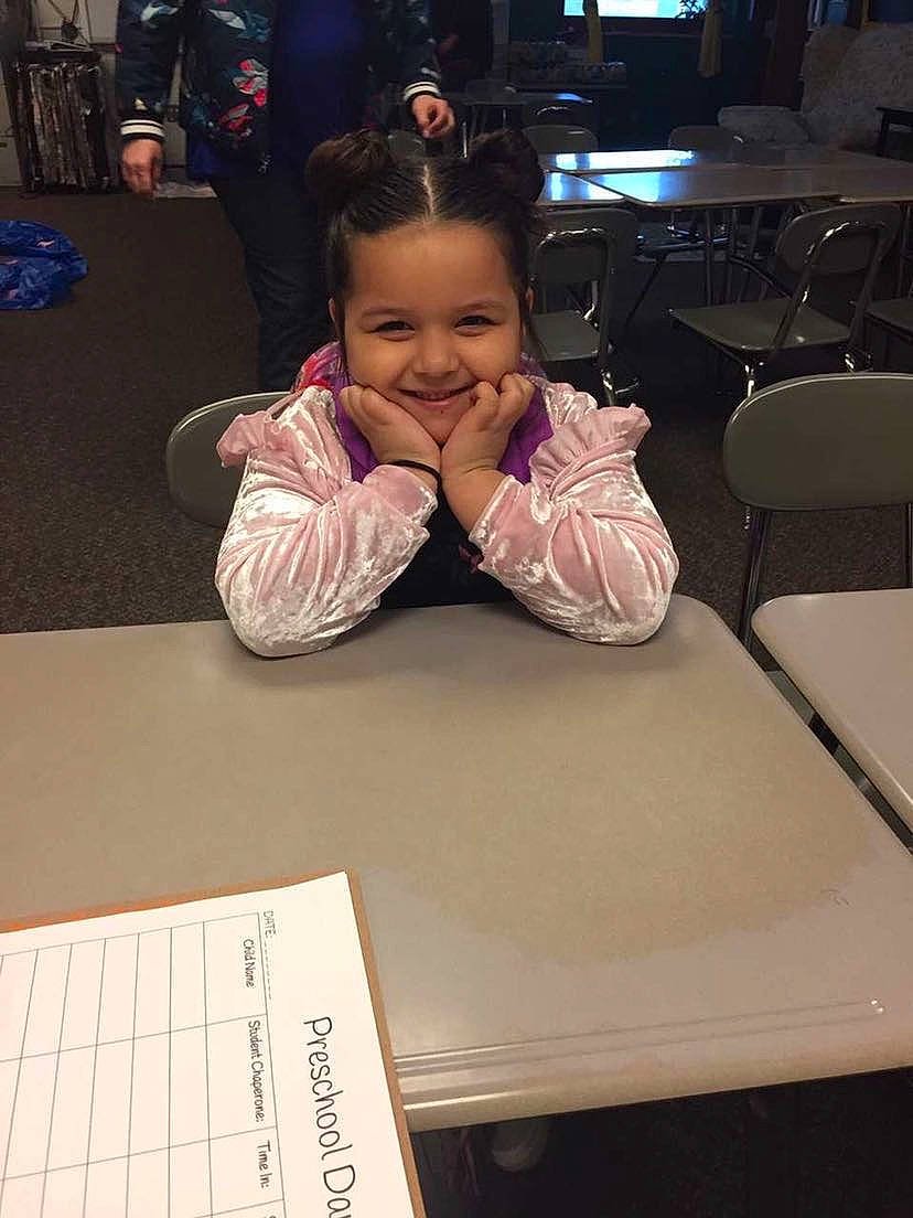 Reyna joined the competition — help win amazing prizes! chair, child, desk, event, eyebrow, finger, flooring, fun, furniture, happy, job, joy, nail, person, sitting, smile, snapshot, table, television, thumb