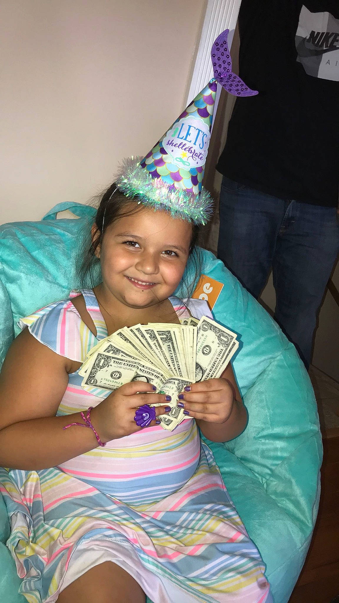 Reyna joined the competition — help win amazing prizes! birthday, birthday_cake, child, cone, costume_hat, event, fun, happy, headwear, icing, joy, leisure, party_hat, party_supply, person, pink, play, room, sitting, smile