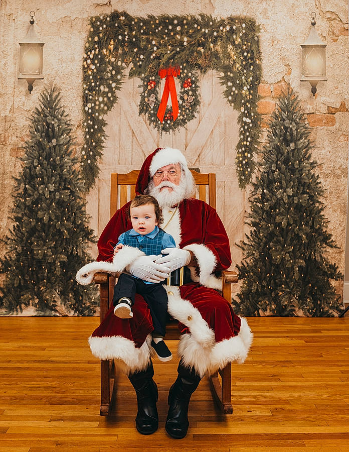 Braylon is registered to the contest to win money with this photo: christmas, christmas_decoration, christmas_eve, christmas_ornament, christmas_tree, event, happy, headwear, holiday, holiday_ornament, lap, ornament, person, plant, santa_claus, toddler, tradition, tree, white, window