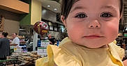 Bella is registered to the contest to win money with this photo: toddler, child, yellow_dress, unicorn_headband, plush_toy, supermarket, shopping_cart, aisle, indoor, person, cute, portrait, baby, face, clothing, shopping, grocery, store, people, headwear
