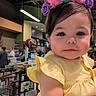 toddler, child, yellow_dress, unicorn_headband, plush_toy, supermarket, shopping_cart, aisle, indoor, person, cute, portrait, baby, face, clothing, shopping, grocery, store, people, headwear