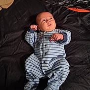Paul joined the competition — help win amazing prizes! baby, infant, onesie, striped_clothing, bed, blanket, sleepwear, child, person, cute, small_hands, face, looking_up, lying_down, indoors, soft_fabric, cozy, newborn, pajamas, resting
