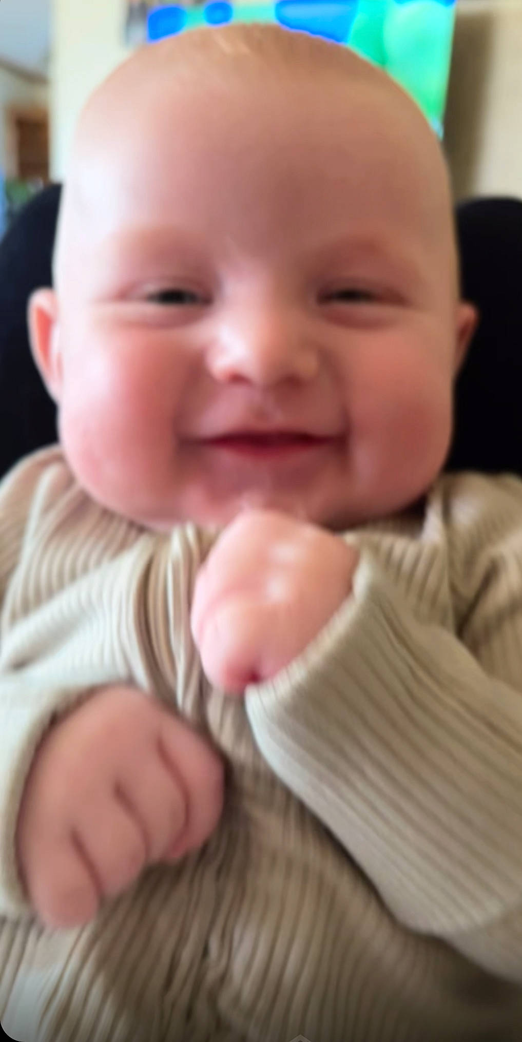 Liam is registered to the contest to win money with this photo: baby, baby_toddler_clothing, cheek, child, chin, close_up, collar, comfort, finger, gesture, happy, iris, joy, lip, nail, nose, person, skin, sleeve, smile