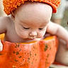 Gabriel joined the competition — help win amazing prizes! baby, infant, child, portrait, orange_hat, curious, looking_down, face, eyes, skin, pumpkin, container, autumn, warm_colors, close_up, indoor, soft_focus, costume, cute, photography