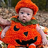 baby, child, infant, pumpkin_costume, halloween, autumn, outdoor, forest, leaves, orange, costume, hat, jack_o_lantern, sitting, blanket, portrait, blue_eyes, wide_eyed, smiling, seasonal