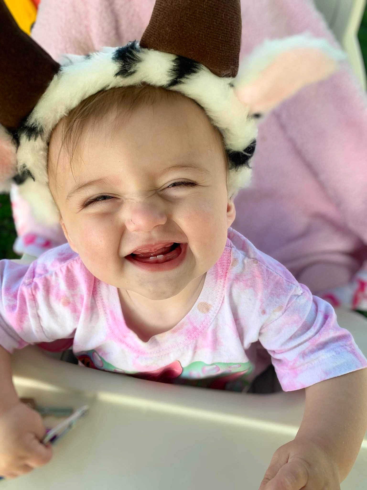 Marley is registered to the contest to win money with this photo: baby, baby_toddler_clothing, cheek, child, event, eye, fun, gesture, happy, iris, joy, laugh, mouth, person, pink, recreation, sitting, skin, smile, sweetness