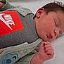 baby, sleeping, infant, clothing, nike_logo, hand, face, blanket, newborn, peaceful, cute, soft, portrait, resting, child, skin, head, eyelashes, cozy, indoors