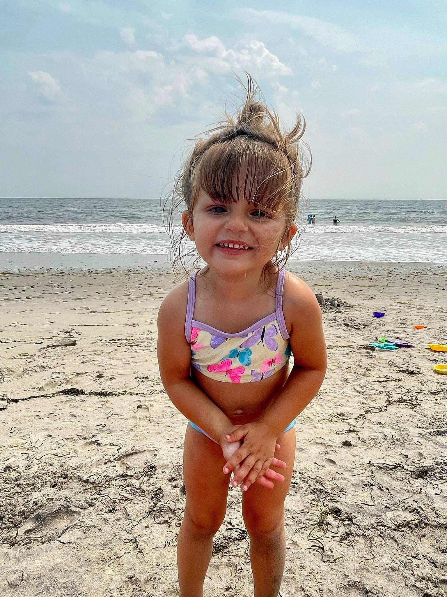 Sage is registered to the contest to win money with this photo: beach, beauty, body_of_water, child, cloud, eye, fun, hair, happy, head, joy, leg, people_in_nature, people_on_beach, person, sky, smile, summer, swimwear, thigh