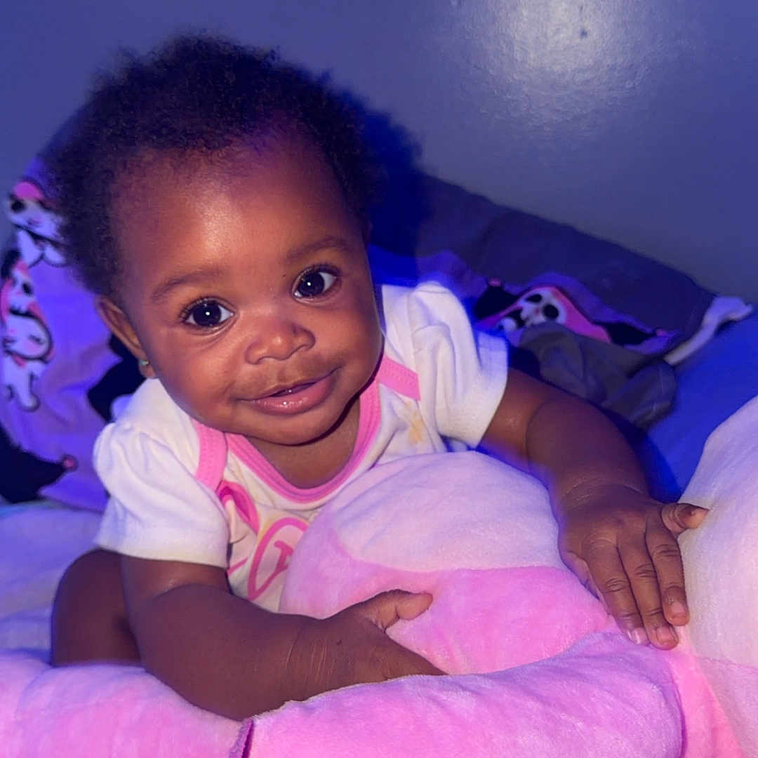 Rumani Peace joined the competition — help win amazing prizes! baby, child, smiling, plush_toy, pink, blanket, cuddling, indoor, cute, happy, person, infant, face, clothing, soft_toy, portrait, toddler, bed, home, cozy