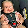baby, car_seat, child, closeup, cute, face, hands, happy, indoor, infant, legs, person, pink_onesie, plump_cheeks, portrait, safety, seatbelt, sitting, smiling, straps