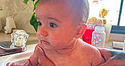Ella is registered to the contest to win money with this photo: baby, bath, blue_eyes, bottle, child, clean, cute, hand, holding, indoor, infant, kitchen, person, plant, sink, skin, tattoo, toddler, water, window