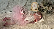 Emberley Hughes is registered to the contest to win money with this photo: baby, blanket, bouquet, cozy, cute, decor, flower_sign, flowers, fur, headband, infant, milestone, newborn, one_month, pacifier, pink_tutu, portrait, resting, sleeping, soft_texture