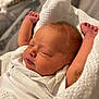 Maddison is registered to the contest to win money with this photo: newborn, baby, sleeping, blanket, white, arms_up, cozy, knitted, infant, soft_light, peaceful, closeup, face, skin, hair, indoors, cute, resting, portrait, child