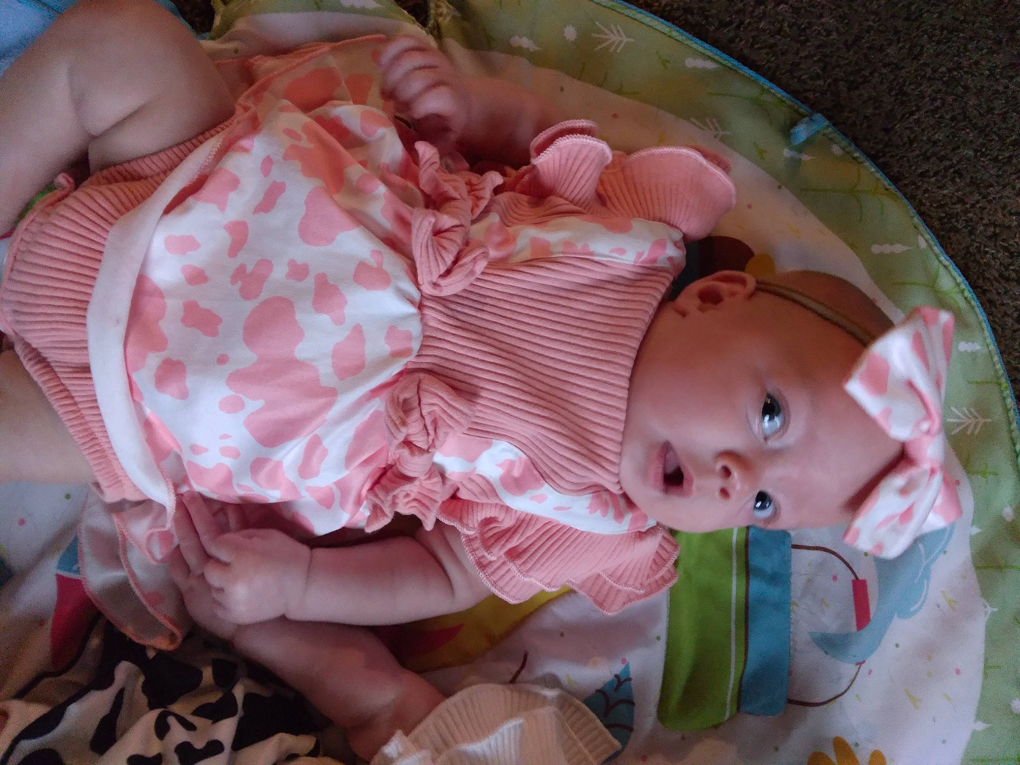 Katie is registered to the contest to win money with this photo: baby, baby_products, baby_toddler_clothing, cheek, chest, child, comfort, eye, facial_expression, finger, headwear, human_body, iris, mouth, nail, pattern, peach, person, pink, room