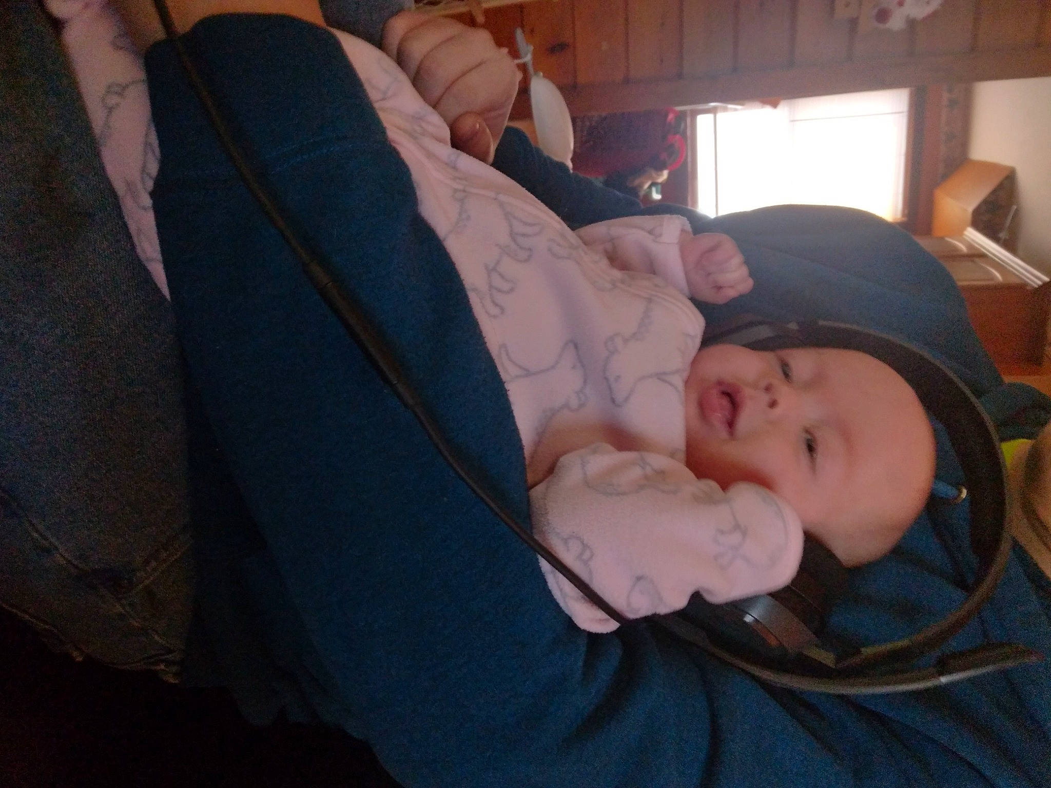 Katie is registered to the contest to win money with this photo: baby, baby_products, baby_toddler_clothing, cheek, child, comfort, fun, hat, human_leg, lap, mammal, mouth, nap, person, room, sitting, skin, thigh, toddler, tree