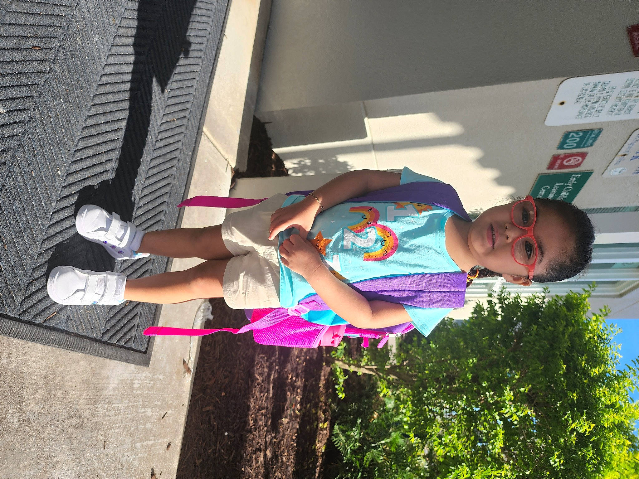 Annalise is registered to the contest to win money with this photo: eyewear, fun, happy, human_leg, knee, leisure, magenta, person, plant, recreation, sandal, t_shirt, thigh, tree, vacation, vehicle_door